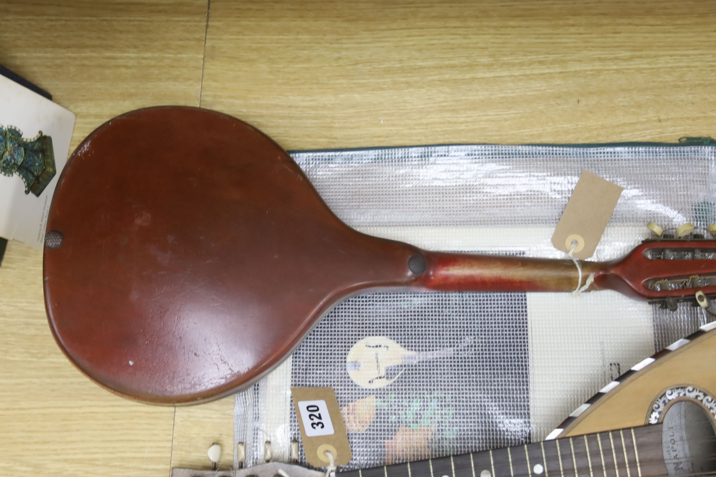 Three Neapolitan mandolins with inlaid mother of pearl decoration, one of round-backed form, the other two archtop